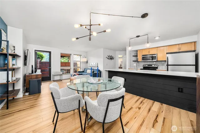 a kitchen with stainless steel appliances kitchen island granite countertop a sink and cabinets