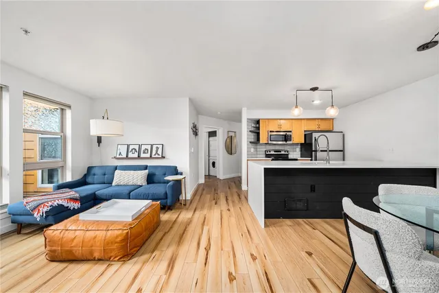 a living room with furniture and a wooden floor