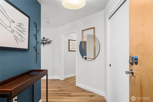 a room with wooden floor and mirror