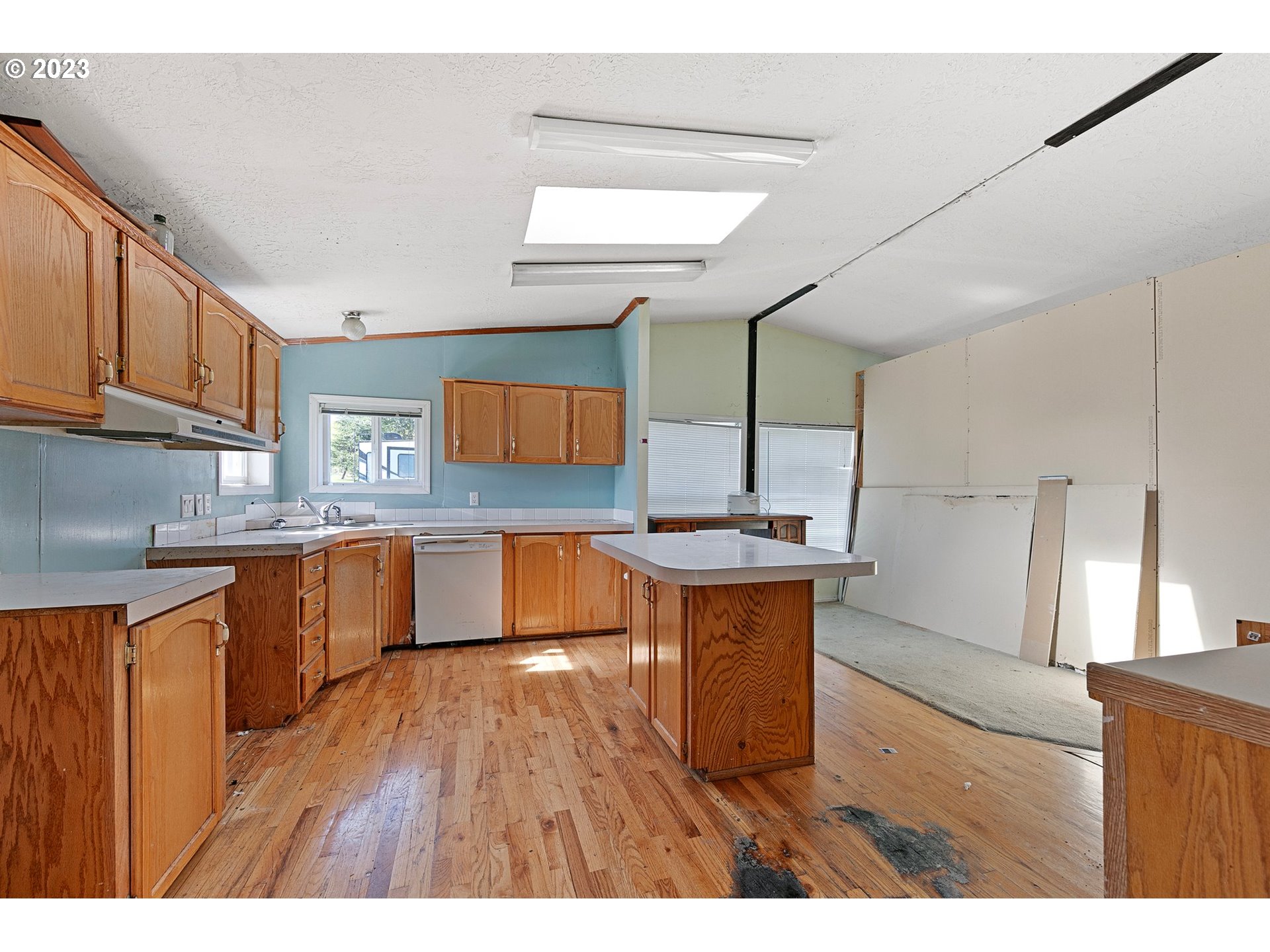 434 Locust Street Yoncalla, OR 97499 - Photo 19 of 36 a kitchen with granite countertop a sink cabinets and wooden floor
