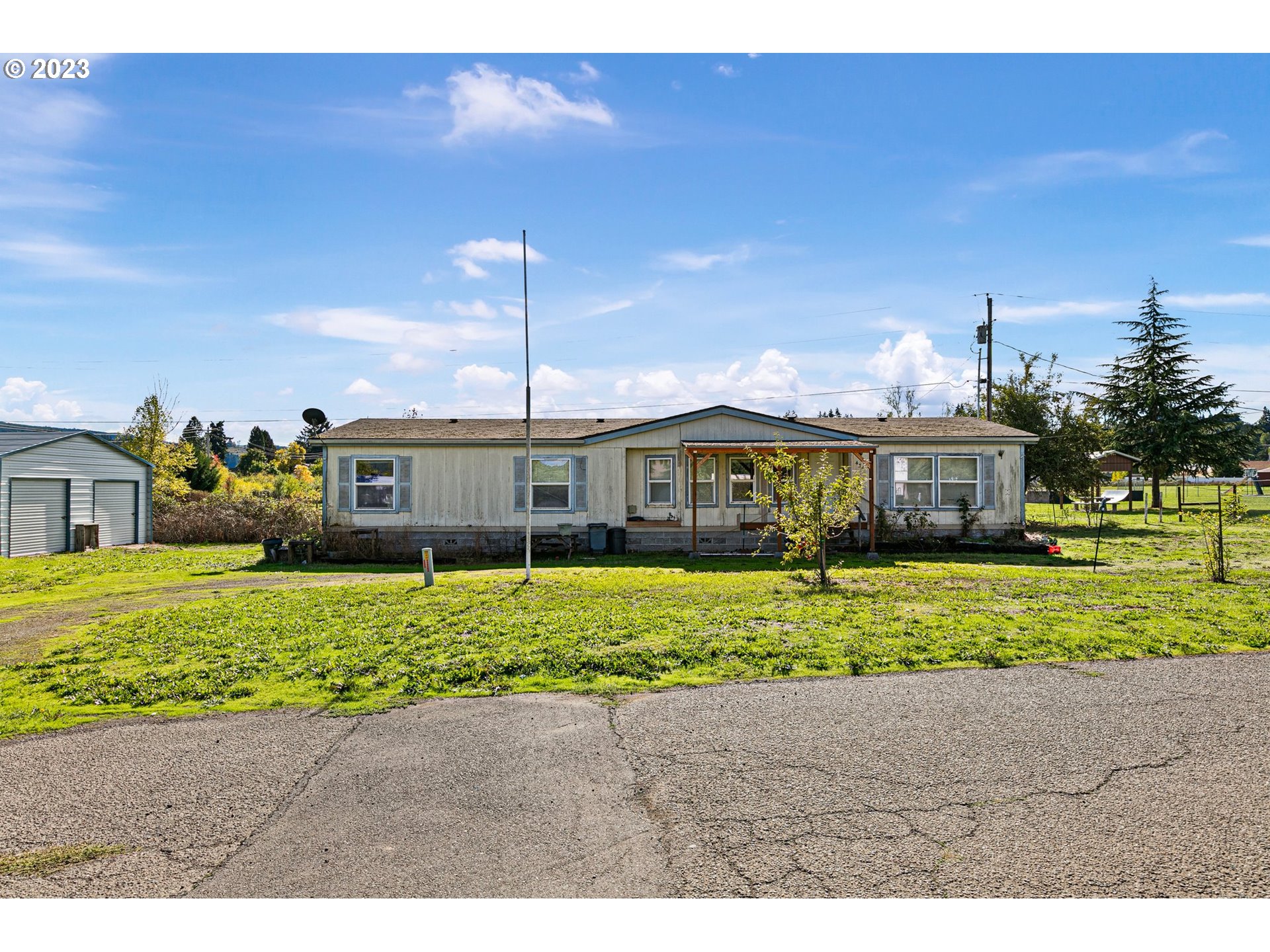434 Locust Street Yoncalla, OR 97499 - Photo 2 of 36 a front view of a house with a garden