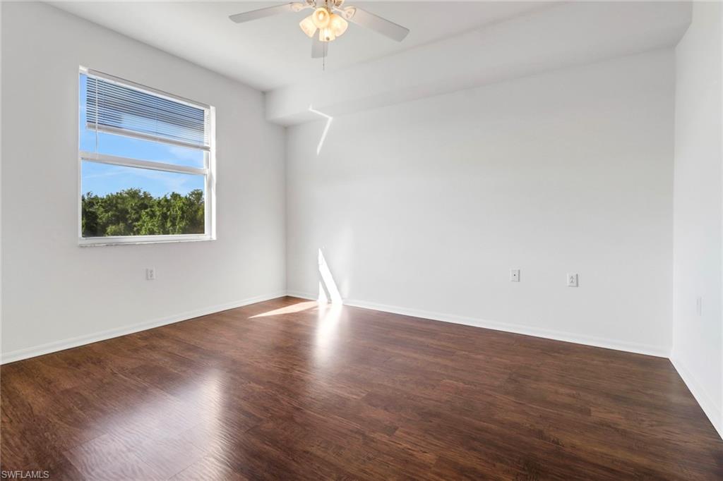 8451 Kingbird Loop, Unit 334 Estero, FL 33967 - Photo 11 of 26 a view of an empty room with wooden floor and a window
