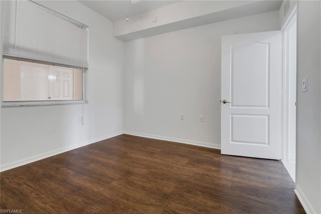 8451 Kingbird Loop, Unit 334 Estero, FL 33967 - Photo 14 of 26 wooden floor in an empty room