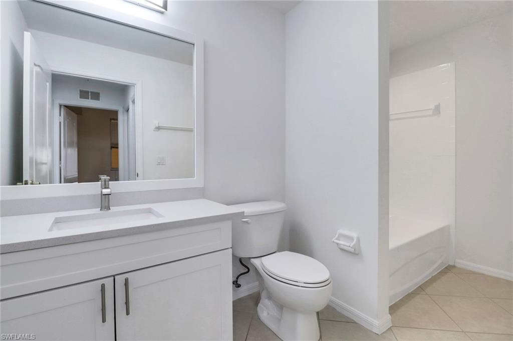 8451 Kingbird Loop, Unit 334 Estero, FL 33967 - Photo 15 of 26 a bathroom with a sink a toilet and mirror