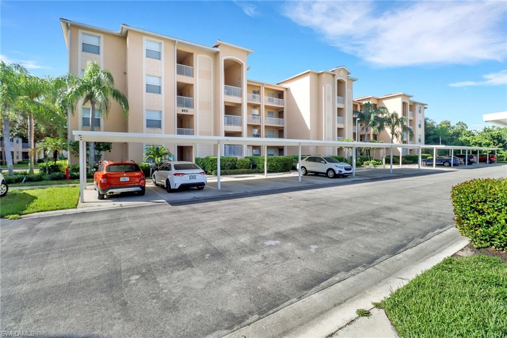 8451 Kingbird Loop, Unit 334 Estero, FL 33967 - Photo 21 of 26 a cars parked in front of a building