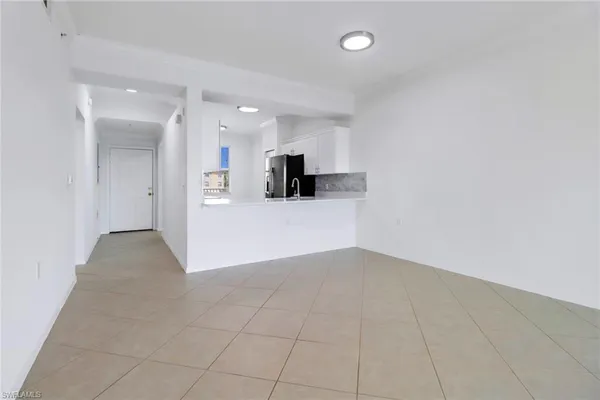 a view of a kitchen with a sink and a refrigerator