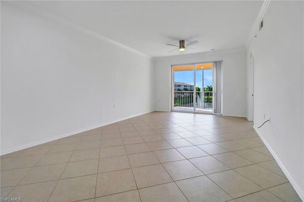 8451 Kingbird Loop, Unit 334 Estero, FL 33967 - Photo 5 of 26 an empty room with a ceiling fan and window