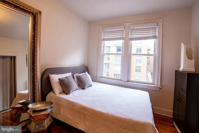 a bedroom with a bed and a window