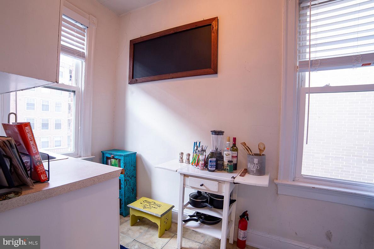 1121 24th Street Northwest, Unit 401 Washington, DC 20037 - Photo 5 of 7 a work room with furniture a flat screen tv and a window