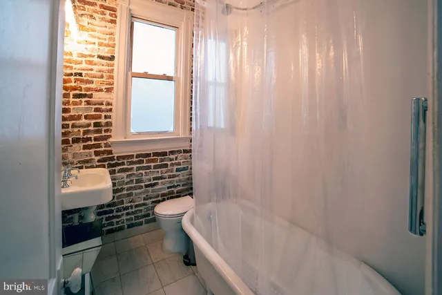 a bathroom with a bathtub and toilet