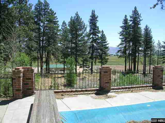 5350 Franktown Road Carson City, NV 89704 - Photo 2 of 9 a view of a deck with a floor to ceiling window next to a yard