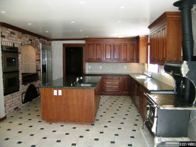 5350 Franktown Road Carson City, NV 89704 - Photo 3 of 9 a kitchen with granite countertop a sink a counter top space and cabinets