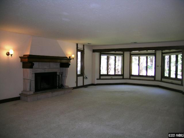 5350 Franktown Road Carson City, NV 89704 - Photo 5 of 9 an empty room with fireplace and windows