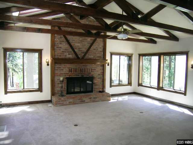5350 Franktown Road Carson City, NV 89704 - Photo 8 of 9 a view of an empty room with a fireplace and a window