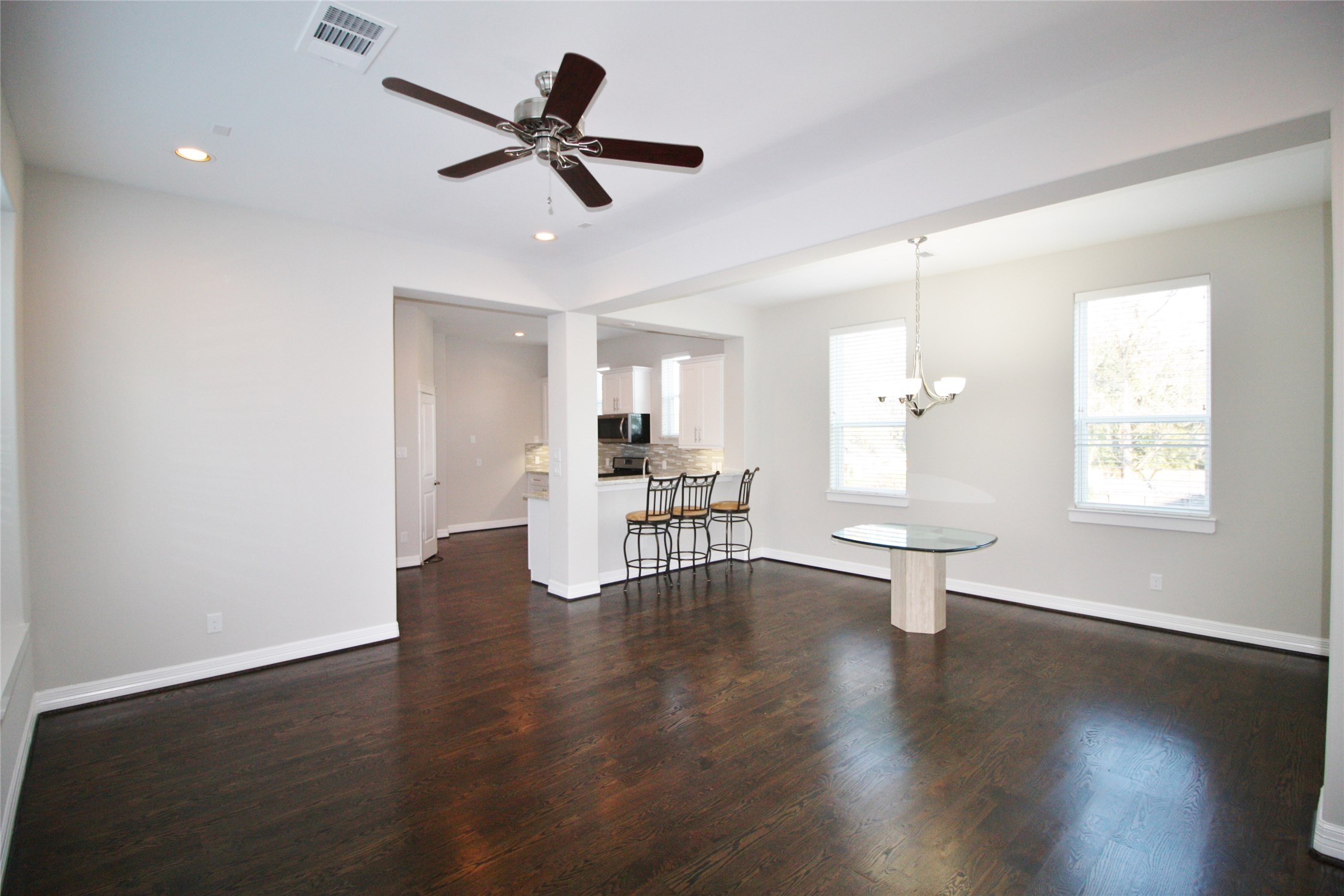 709 Link Road Houston, TX 77009 - Photo 4 of 46 a view of an empty room with wooden floor and a ceiling fan