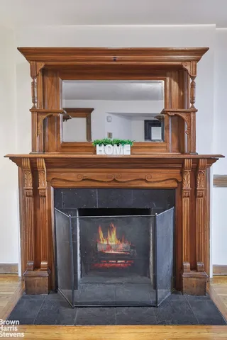 a fireplace with a clock on wall