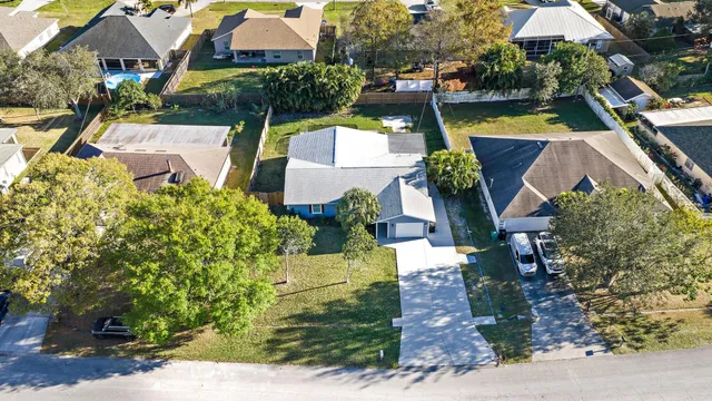 an aerial view of a house with a garden and swimming pool