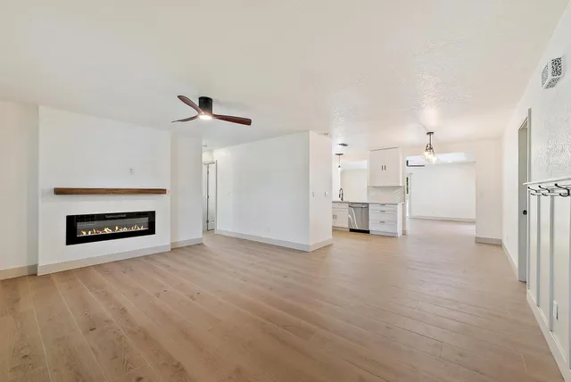 a view of a livingroom with a fireplace and wooden floor