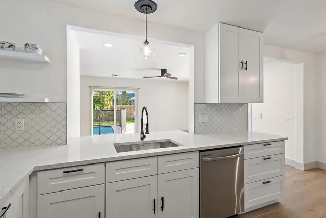 a kitchen with appliances cabinets and a sink