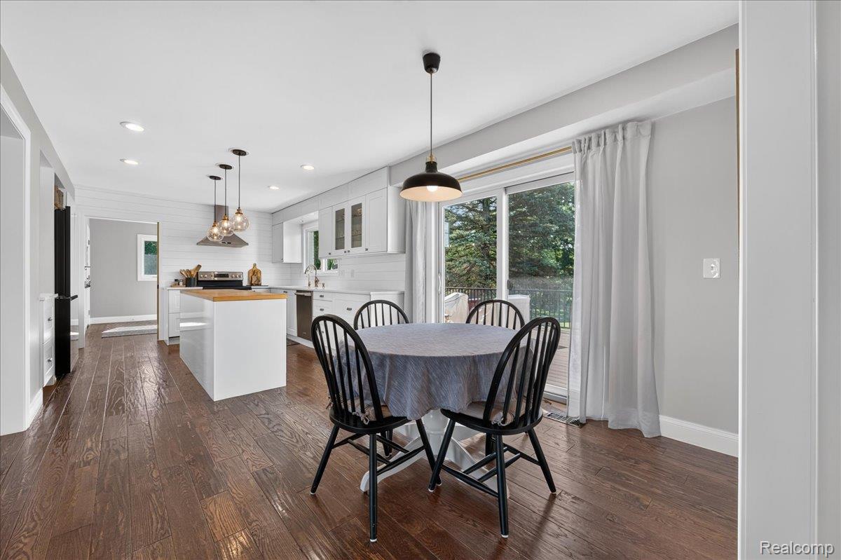 7330 West Gates Street Romeo, MI 48065 - Photo 18 of 73 Wood-finish flooring, white cabinetry, stainless steel appliances, recessed lighting, and a sliding glass door