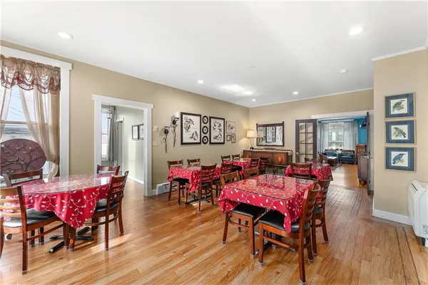 a view of a dining room with furniture and wooden floor