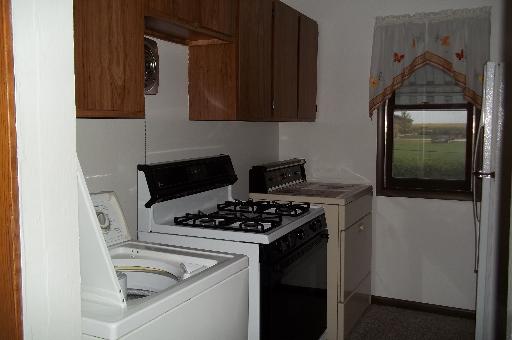 345 Porter Avenue Grand Ridge, IL 61325 - Photo 7 of 14 a kitchen with granite countertop a stove and a microwave