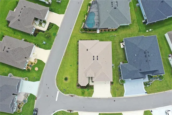 an aerial view of multiple houses with yard