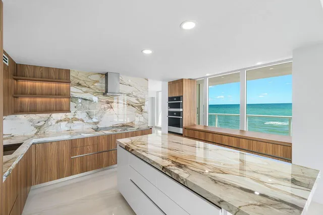a kitchen with granite countertop sink and stove