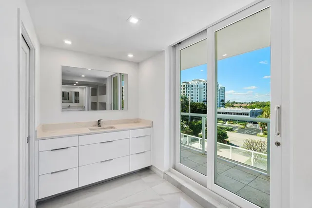 a bathroom with a double vanity sink and mirror with shower