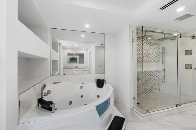 a bathroom with a tub and a shower