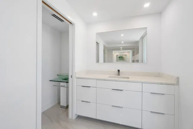 a bathroom with a sink a vanity and mirror