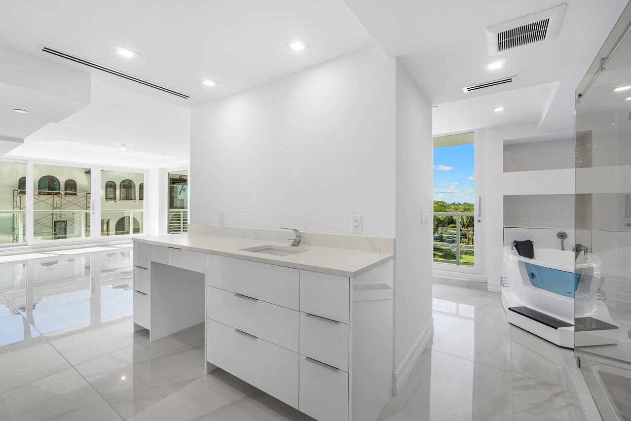 3505 South Ocean Boulevard, Unit 4S Highland Beach, FL 33487 - Photo 37 of 48 a large white kitchen with a sink and dishwasher with a large window