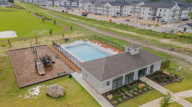 a view of a swimming pool with a yard