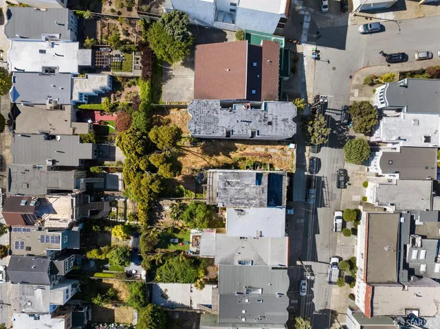 an aerial view of residential houses with outdoor space