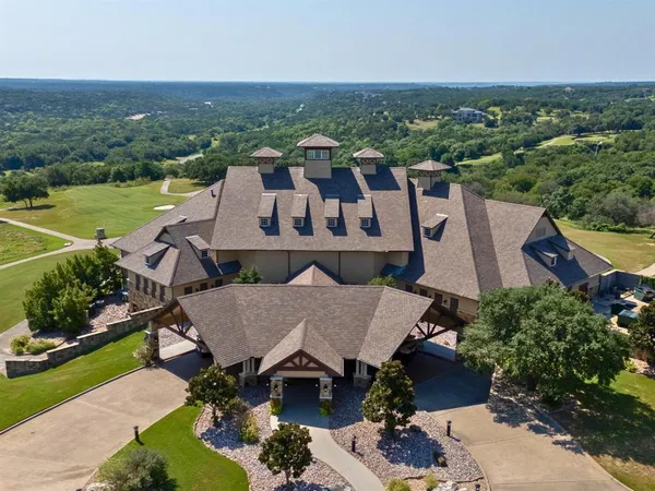 an aerial view of a house with a garden and lake view