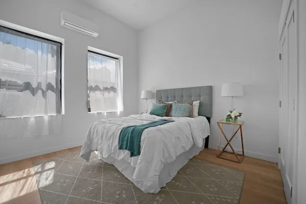 a bedroom with a bed and window