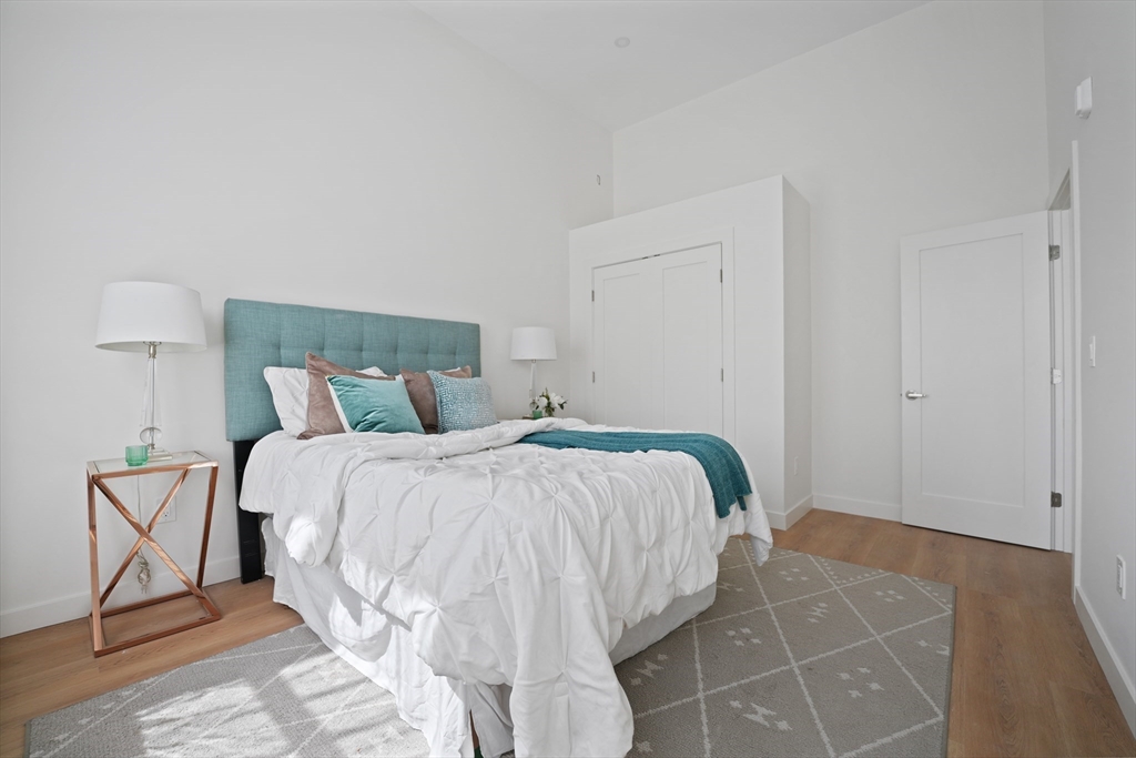 403 Division Street, Unit 11 Fall River, MA 02721 - Photo 22 of 27 a bed sitting in a bedroom with a lamp