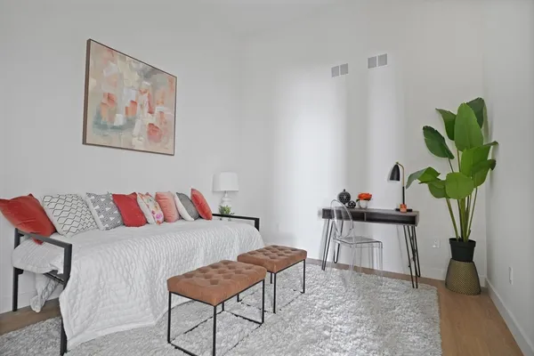 a living room with furniture flowerpot and a potted plant