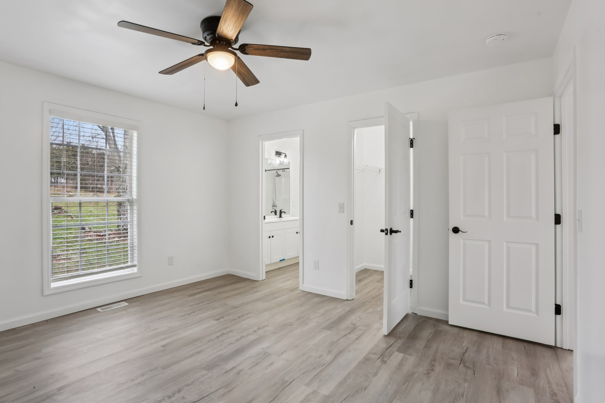 1101 Bugscuffle Road Wartrace, TN 37183 - Photo 29 of 42 a view of an empty room with wooden floor and a window