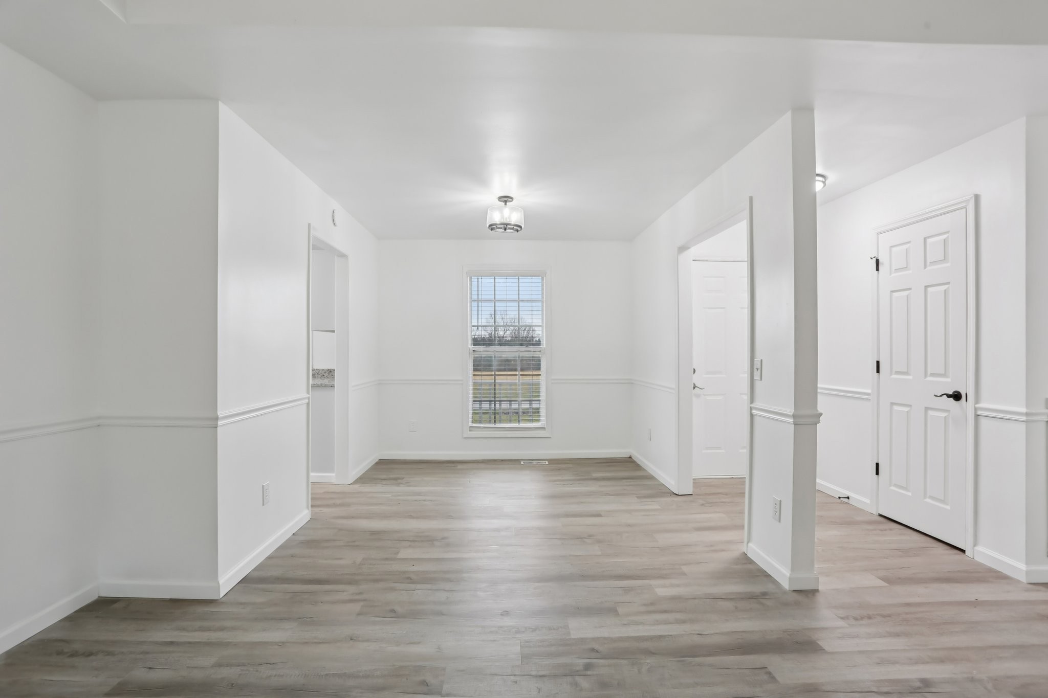 1101 Bugscuffle Road Wartrace, TN 37183 - Photo 10 of 42 an empty room with wooden floor cabinet and windows