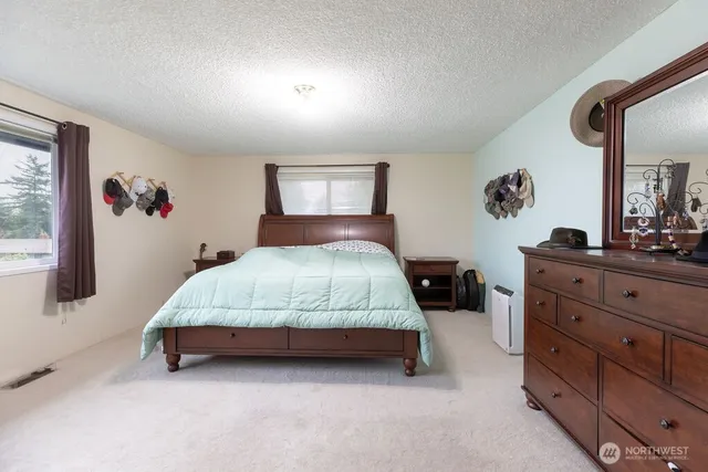 a bedroom with a bed and a dresser