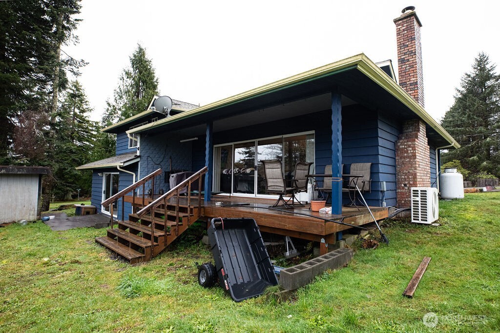 194 Sekiu Airport Road Sekiu, WA 98381 - Photo 30 of 40 a view of a house with a backyard and wooden deck