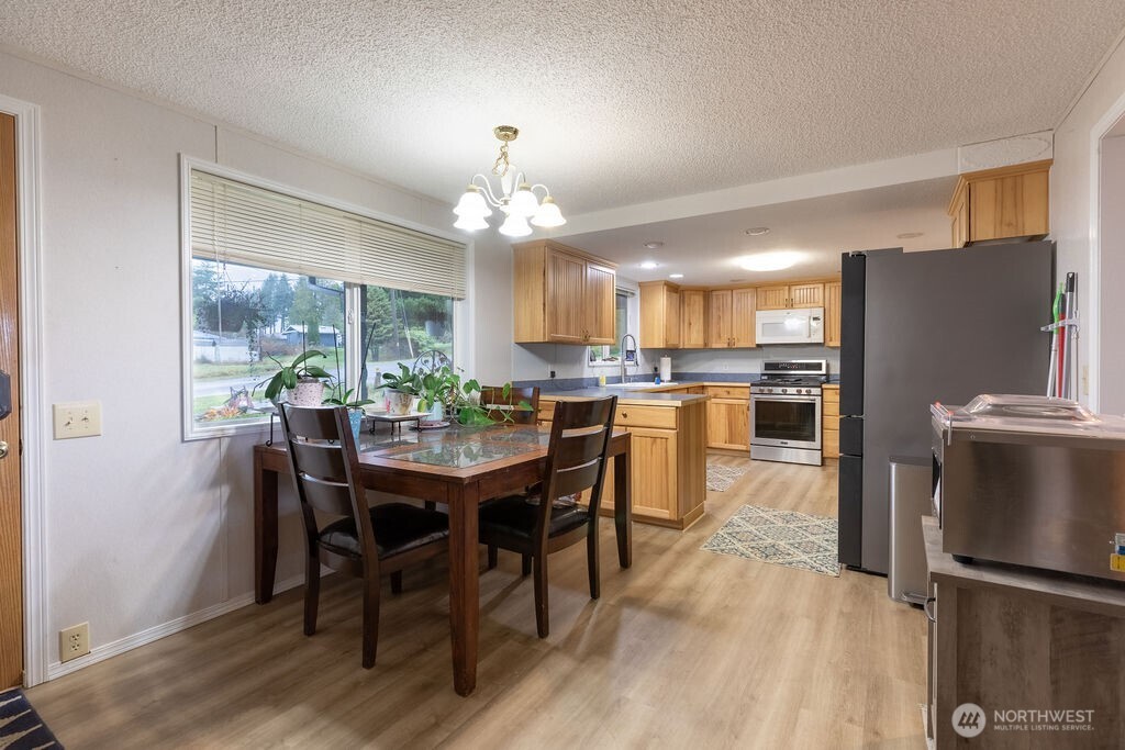 194 Sekiu Airport Road Sekiu, WA 98381 - Photo 7 of 40 a view of a dining room with furniture window and wooden floor