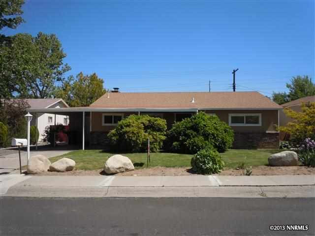 2420 Riviera Street Reno, NV 89509 - Photo 1 of 1 a front view of a house with a yard and garage