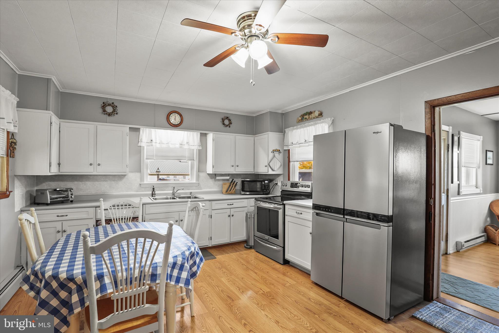 3220 Mt Carmel Road Upperco, MD 21155 - Photo 2 of 44 a kitchen with stainless steel appliances granite countertop a refrigerator a stove a sink a dining table and chairs with wooden floor