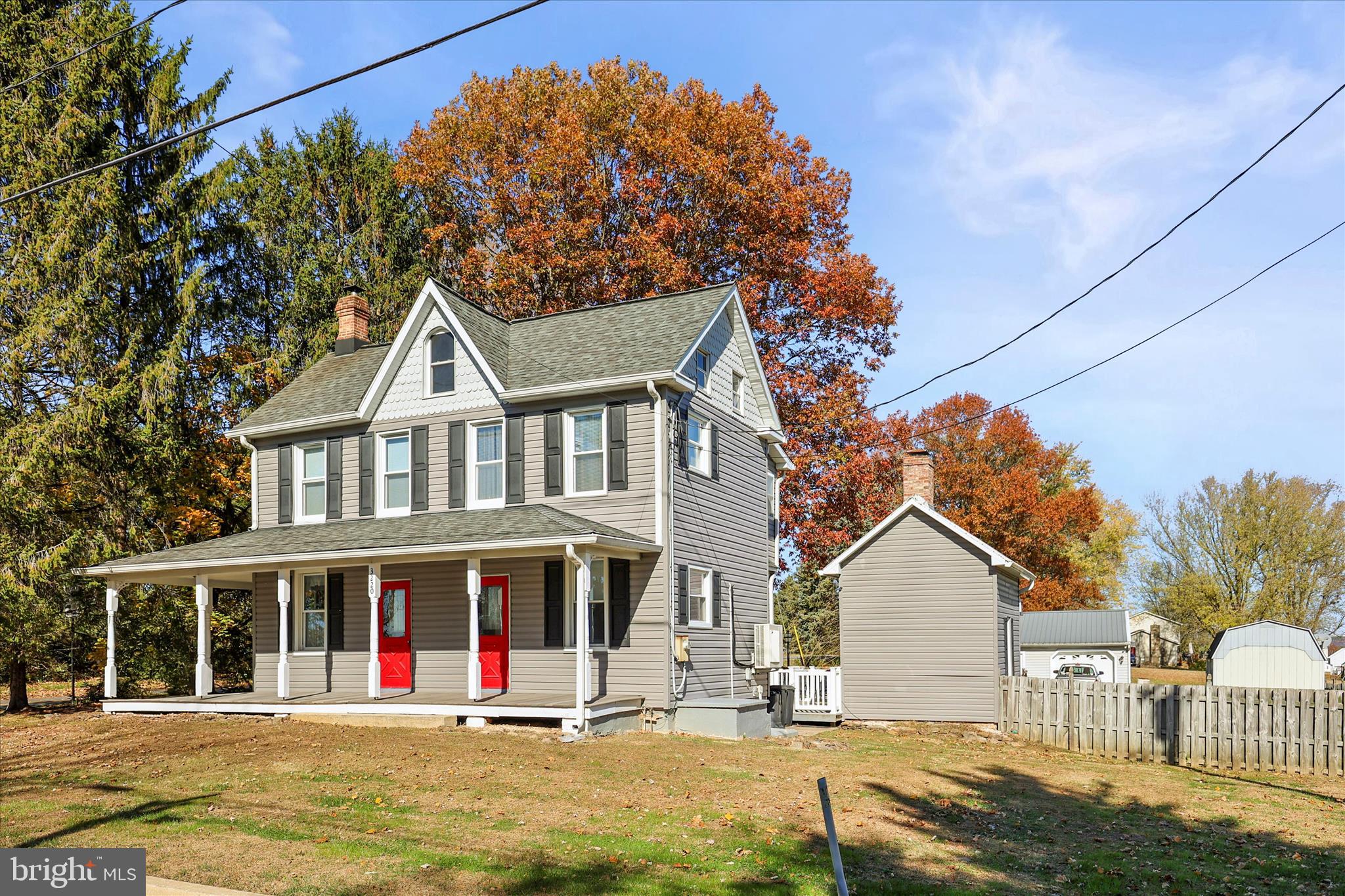 3220 Mt Carmel Road Upperco, MD 21155 - Photo 38 of 44 a view of a white house with large windows and a small yard