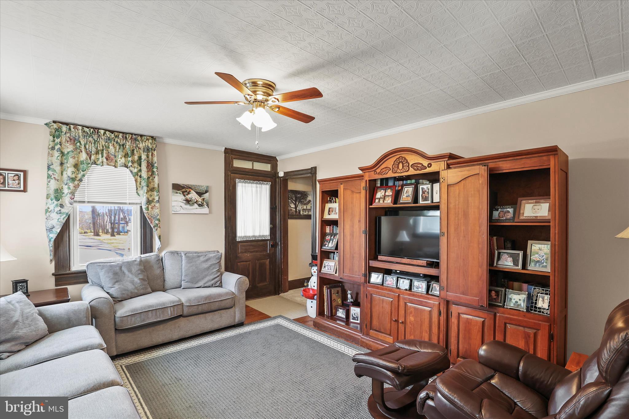 3220 Mt Carmel Road Upperco, MD 21155 - Photo 5 of 44 a living room with furniture a flat screen tv and a bookshelf