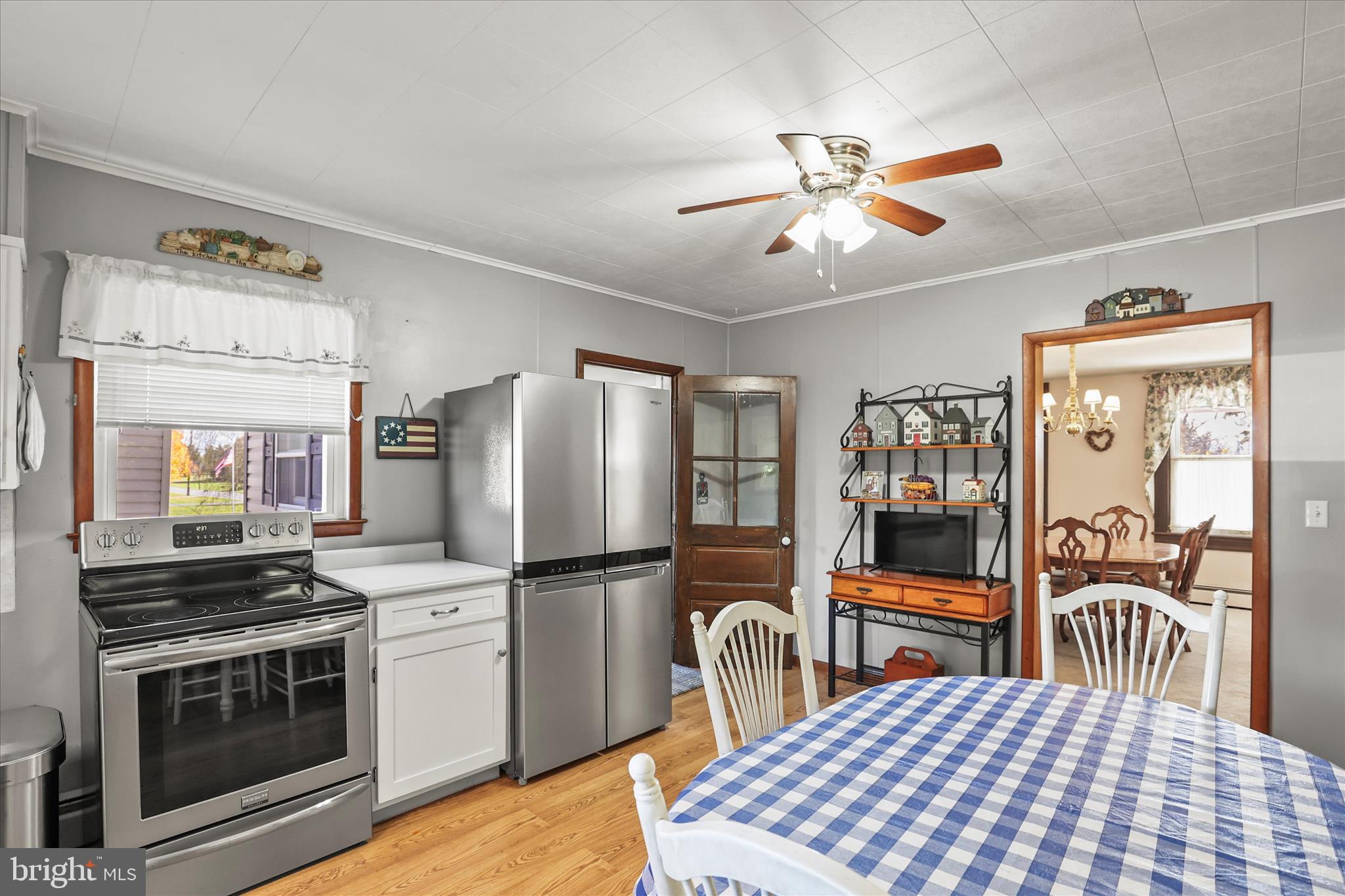 3220 Mt Carmel Road Upperco, MD 21155 - Photo 7 of 44 a kitchen with a stove a refrigerator and a dining table