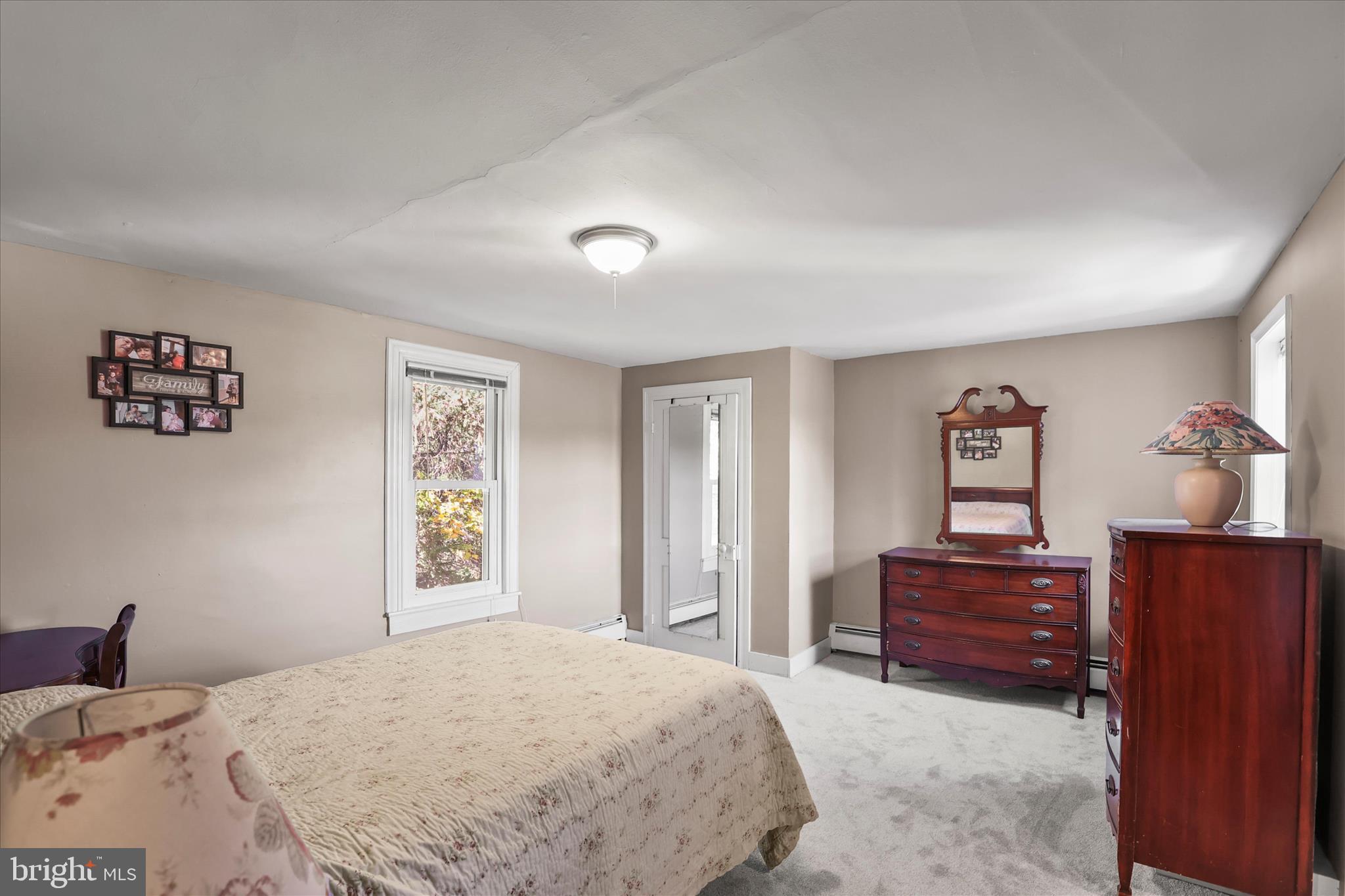 3220 Mt Carmel Road Upperco, MD 21155 - Photo 10 of 44 a bedroom with a bed and a dresser