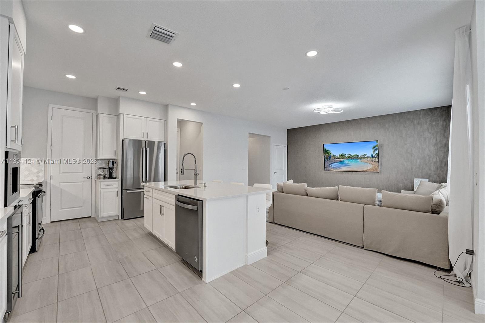 1033 Eucalyptus Drive Hollywood, FL 33021 - Photo 14 of 66 a kitchen with stainless steel appliances a refrigerator and a cabinets